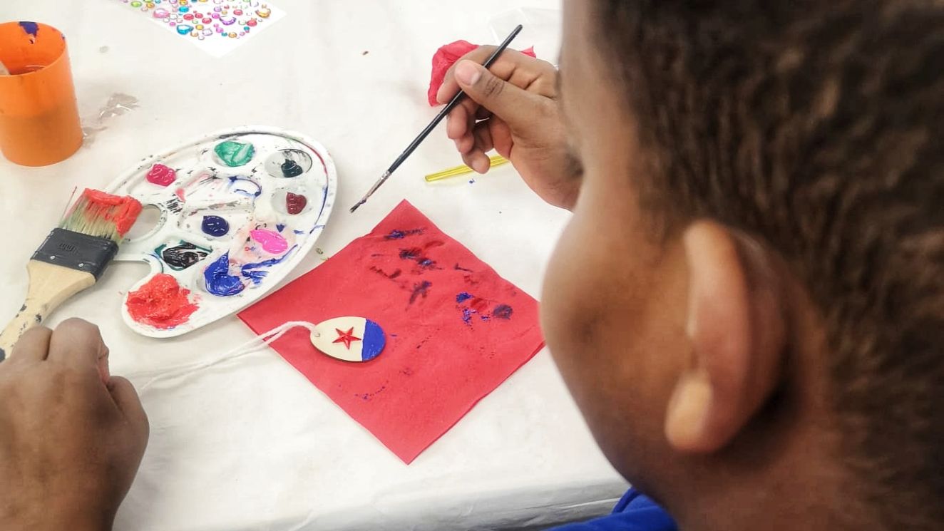 Junge malt mit Pinsel und Farbe